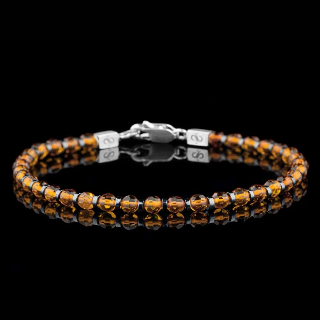 A gold bracelet on a black background.