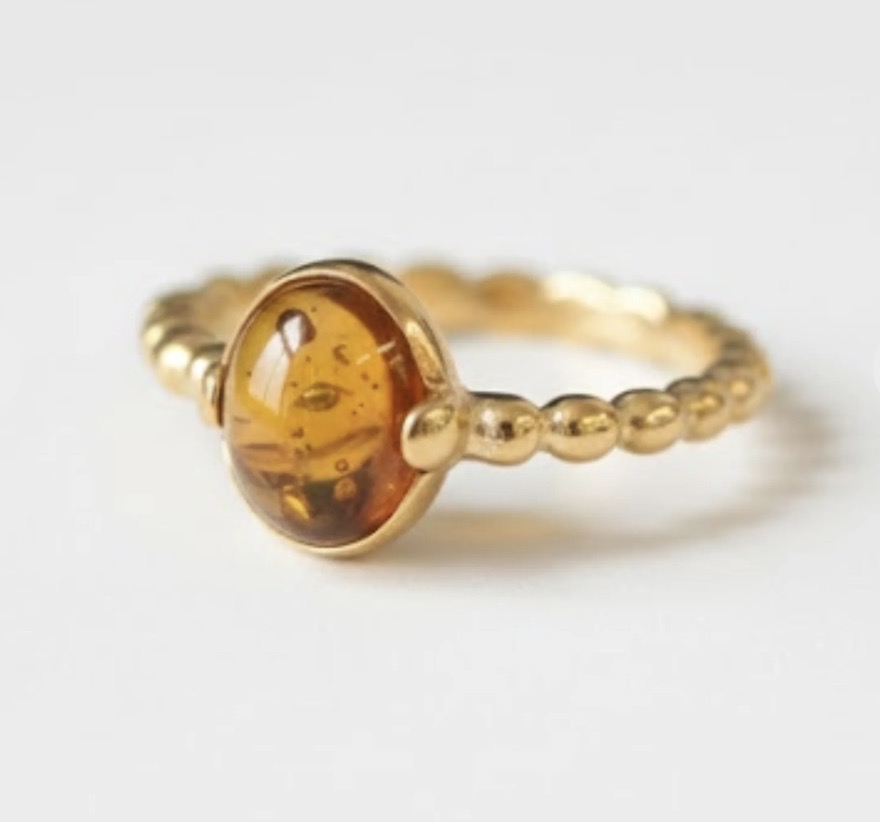 A gold ring with an amber stone.