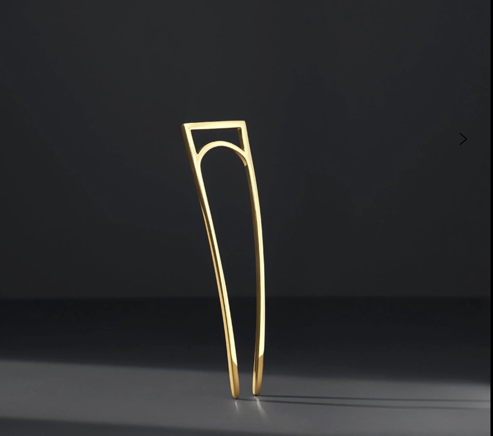 A gold simple hair pin.